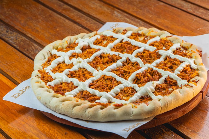 Chicken Pesto pizza with grilled chicken and sun-dried tomatoes